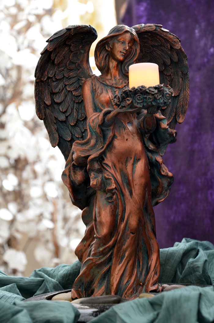 A winged angel holding a candle in Karen's office